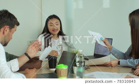 Business team sharing ideas about the financial development of their company. They are discussing over financial data and graphs. Business team sharing ideas about the financial development of their company. They are discussing over financial data and graphs. 78310843