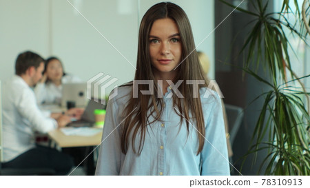 Smiling beautiful female professional manager employee standing in modern office looking at camera, happy confident business woman corporate leader boss or intern portrait. Smiling beautiful female professional manager employee standing in modern office looking at camera, happy confident business woman corporate leader boss or intern portrait. 78310913