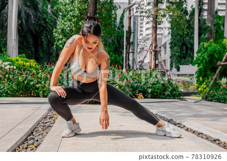 Asian sport girl doing stretching, yoga fitness and plank exercise outside. Fit young thai woman 78310926