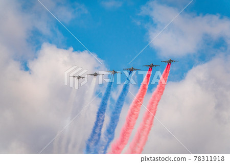 Moscow, Russia - May, 05, 2021: Eight attack aircrafts Su-25 fly with smoke, painted in the colors of the Russian flag. Parade in honor of Victory in the Great Patriotic War in Moscow. 78311918
