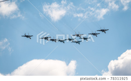 Moscow, Russia - May, 05, 2021: Fighters Su-35S and Su-30SM with bombers Su-34 in the blue sky over Red Square in the group Tactical Wing. Aviation part of Victory parade in Moscow 78311925