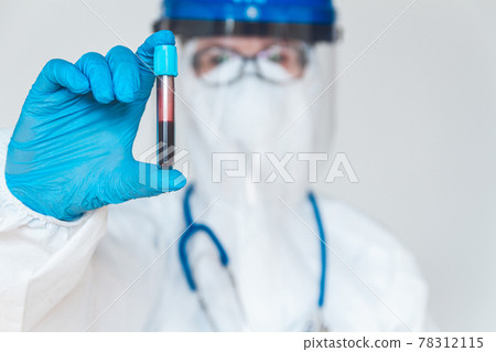 Female doctor or nurse in protective suit holding a positive blo 78312115