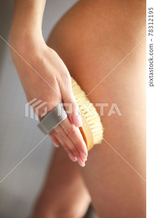 Young woman scrubbing her body Young woman scrubbing her body 78312195