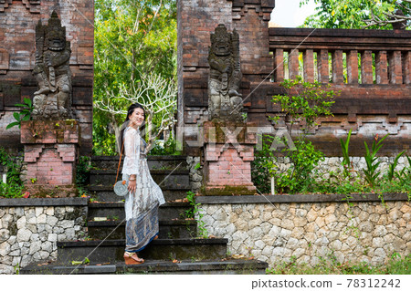 A woman on a sightseeing trip in Bali 78312242