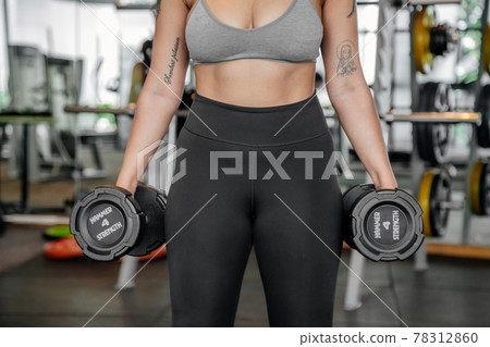 Asian sports woman in the gym, athletes training, workout lifting weight, plank and push up. tattoo Asian sports woman in the gym, athletes training, workout lifting weight, plank and push up. tattoo 78312860