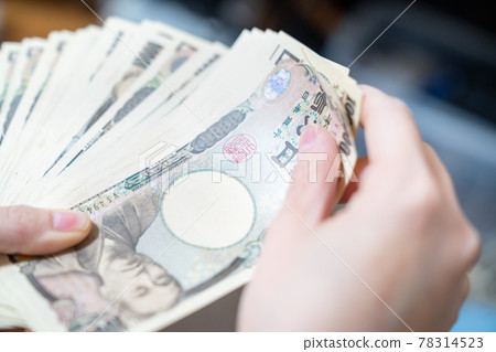 A photo of a large number of 10,000 yen bills in hand. The image of a rich man. A photo of a large number of 10,000 yen bills in hand. The image of a rich man. 78314523