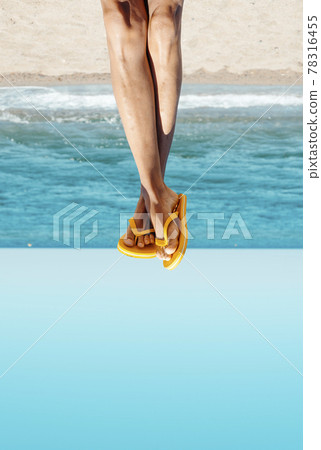 man wearing flip-flops on the beach, upside-down 78316455