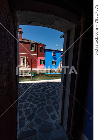 Burano Island in Venice Lagoon Italy - Multi Colored Houses and Canal with Small Boats Burano Island in Venice Lagoon Italy - Multi Colored Houses and Canal with Small Boats 78317575