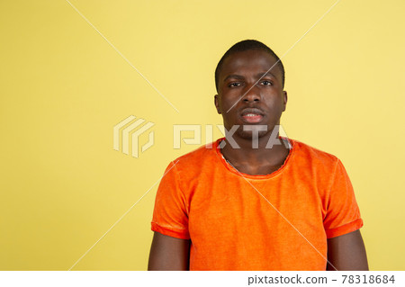 African american young male portrait isolated on yellow studio background with copyspace for ad. African american young male portrait isolated on yellow studio background with copyspace for ad. 78318684