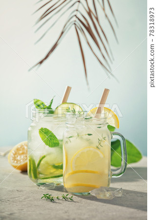 Lemonade and mojito on blue sky background close up 78318973