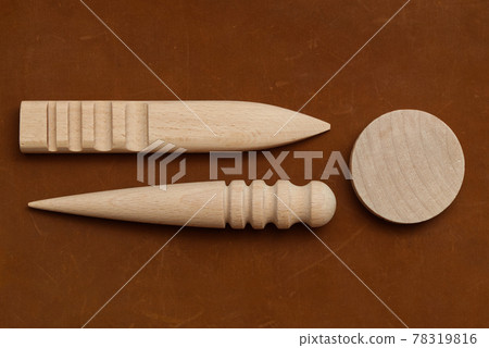 Multi-Size Burnisher, Leather Craft Round Wood Edge Slicker for Leather Craft on Genuine Leather Background. Multi-Size Burnisher, Leather Craft Round Wood Edge Slicker for Leather Craft on Genuine Leather Background. 78319816