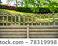 Log retaining wall and low bamboo fence 78319998