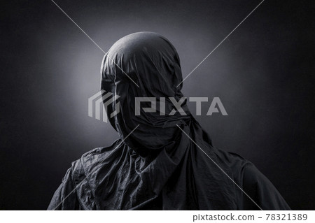 Creepy figure over dark misty background 78321389