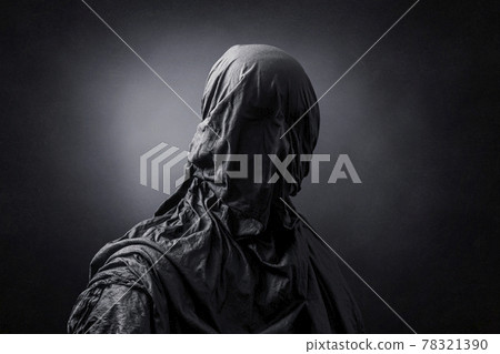 Creepy figure over dark misty background 78321390