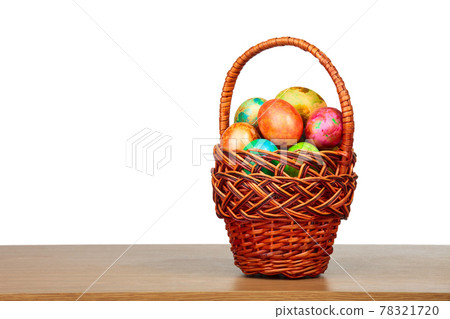 Colored easter eggs in a basket isolated 78321720