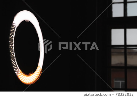 Circular LED light glowing in dark studio Circular LED light glowing in dark studio 78322032