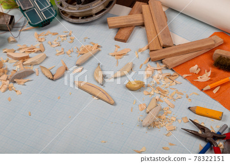 Handmade wooden fishing tacles graph paper background with tools and blanks. 78322151