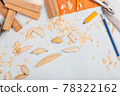 Handmade wooden fishing tacles graph paper background with tools and blanks. 78322162