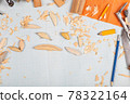 Handmade wooden fishing tacles graph paper background with tools and blanks. 78322164