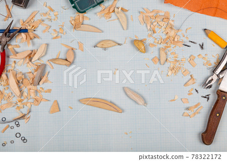 Handmade wooden fishing tacles graph paper background with tools and blanks. Handmade wooden fishing tacles graph paper background with tools and blanks. 78322172