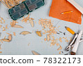 Handmade wooden fishing tacles graph paper background with tools and blanks. 78322173