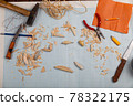 Handmade wooden fishing tacles graph paper background with tools and blanks. 78322175
