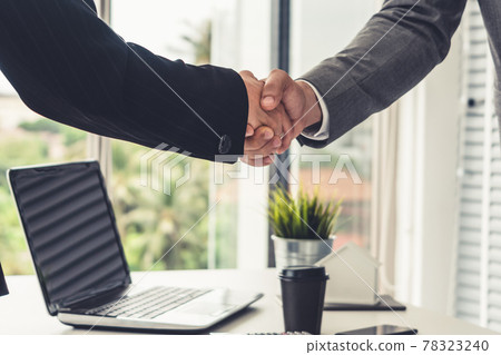 Businessman handshake businesswoman in office. 78323240