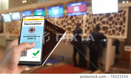 Traveler holds vaccine passport certificate to show COVID 19 vaccination status Traveler holds vaccine passport certificate to show COVID 19 vaccination status 78323334