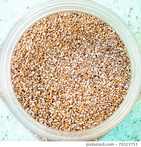 top view of broken wheat groats in glass jar top view of broken wheat groats in glass jar 78323753