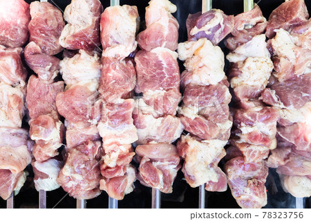 raw skewered shish kebabs on brazier 78323756