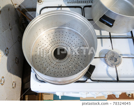 view of empty metal steamer pot for Manti cooking 78324045