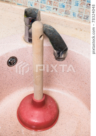 common plunger in used kitchen sink common plunger in used kitchen sink 78324048