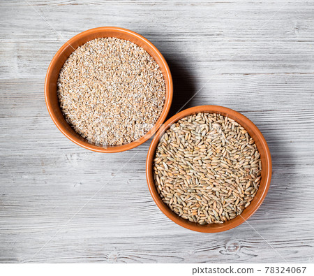 rye groats and grains in round ceramic bowls 78324067