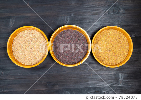 top view of white, black, yellow mustard seeds 78324075