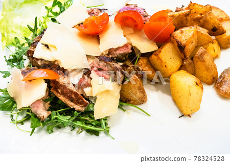 sliced roast beef with rustic roasted potatoes 78324528