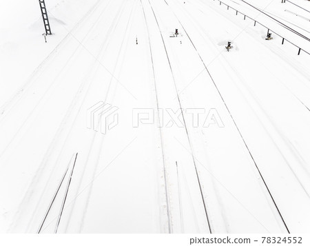 above view of snow-covered railways at station 78324552