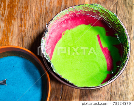 springform pan with green and red liquid doughs 78324579