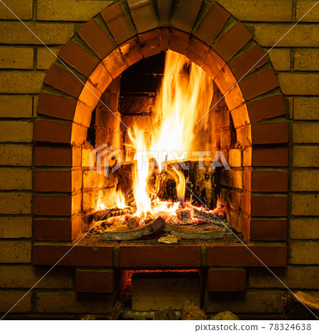 front view of brick fireplace with fire 78324638
