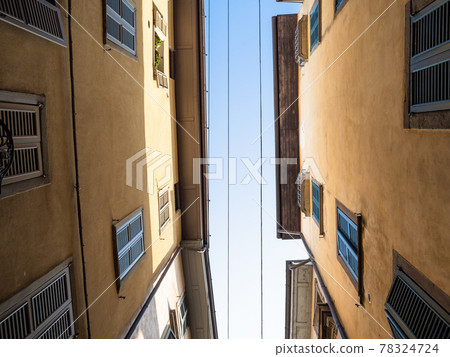 bottom view of blue sky between apartment houses 78324724