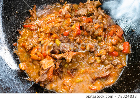 pottage from lamb and vegetables in iron cauldron 78324838