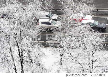 cars driving on wet city road on winter day 78324891