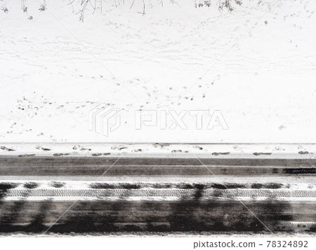 footprints on snow-covered roadside in winter footprints on snow-covered roadside in winter 78324892