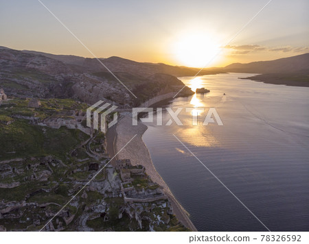 Aerial Drone Shot at sunset Time on the Tigres River in Eastern Turkey, Mesopotamia, the ancient city of Hasankeyf, caves in the rock 78326592