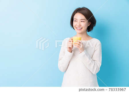 A woman drinking a drink A woman drinking a drink 78333967