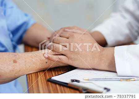 Holding Touching hands Asian senior or elderly old lady woman patient with love, care, helping, encourage and empathy at nursing hospital ward : healthy strong medical concept . 78337791