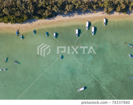 Many fishing boats on the water near the shore Many fishing boats on the water near the shore 78337980