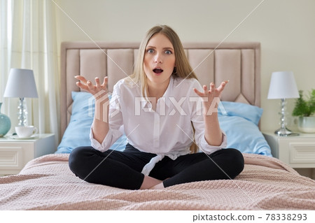 Serious anxious worried young woman sitting at home in bed 78338293