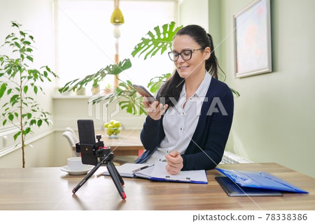 Business woman working remotely using video call Business woman working remotely using video call 78338386