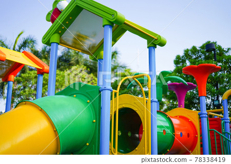 Playground for kid children having fun with colorful slide at yard activities in public park. Playground for kid children having fun with colorful slide at yard activities in public park. 78338419