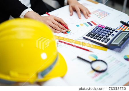 Architect or engineer working project accounting with graph with tools in office, Construction account concept. . Architect or engineer working project accounting with graph with tools in office, Construction account concept. . 78338750